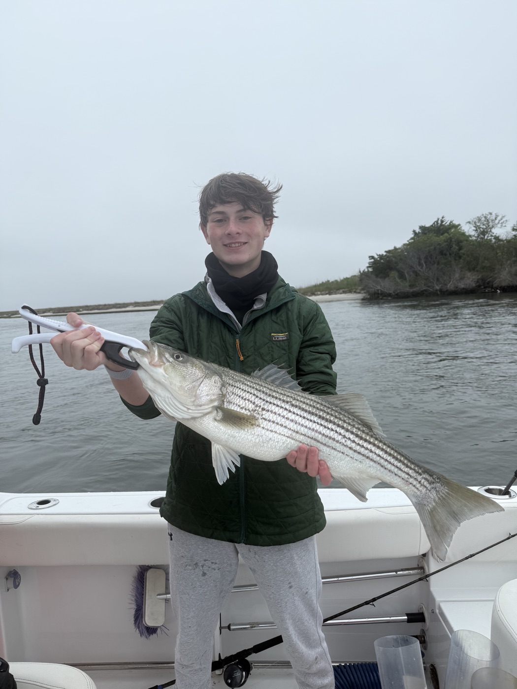 Young angler with a striped bass