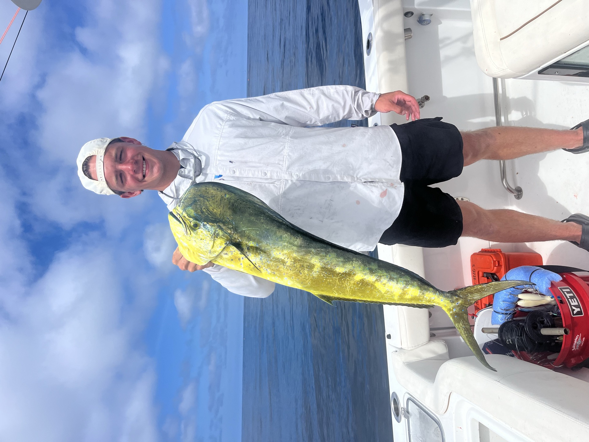 Angler holding a mahi mahi offshore near Stuart